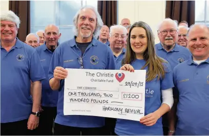  ??  ?? Members of Harmony Revival hand the cheque over to The Christie Hospital