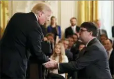  ?? EVAN VUCCI - THE ASSOCIATED PRESS ?? President Donald Trump shakes hands with Acting Veterans Affairs Secretary Robert Wilkie, during an event on prison reform in the East Room of the White House, Friday in Washington. Trump announced he’s nominating Wilkie to lead the agency.