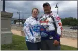  ?? RICHARD PAYERCHIN — THE MORNING JOURNAL ?? Angler William Gaines of Plymouth, Ind., stands for a photo with his new fiancee, Jodie Leasure, while taking a break from the Cabela’s National Team Championsh­ip walleye tournament in Lorain on June 9.