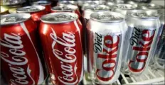  ?? Associated Press ?? In this March 17, 2011, file photo, cans of Coca-Cola and Diet Coke sit in a cooler at a deli in Portland, Ore.