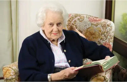  ?? Picture: AFP ?? PROUD CHEF. Angela Wood holds a copy of the original cook book, The Constance Spry Cookery Book, where her Coronation recipe appears at her home in Kimbolton, north of London, on Wednesday.