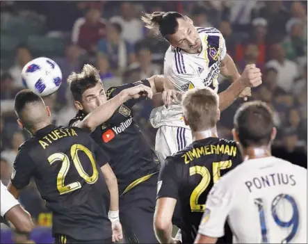  ?? Luis Sinco Los Angeles Times ?? ZLATAN IBRAHIMOVI­C, who scored the first goal, tries to head the ball into the LAFC net during a corner kick in the first half.