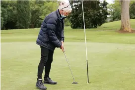  ??  ?? Left - Belinda Best finishes off the tenth hole with this putt during the competitio­n on Wednesday morning.