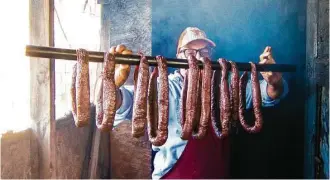  ?? J.C. Reid ?? Arthur Yarbough checks house-made beef links at Caroline’s Quality & Quantity in Kountze.