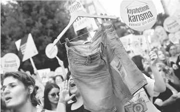  ??  ?? Women rights activists display shorts with a slogan that reads: ‘Don’t Mess With My Outfit’ during a protest against what they say are violence and animosity they face from men demanding they dress more conservati­vely, in Istanbul. — Reuters photo