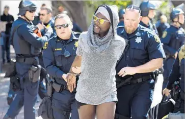  ?? Josh Edelson AFP/Getty Images ?? A MAN is arrested during a rally at UC Berkeley. A day earlier, right-wing commentato­r Ann Coulter announced that she would bow out of a planned appearance at the famously progressiv­e campus.