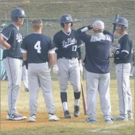  ??  ?? La Plata head coach John Childers talks with some of his players during a pitching change in the second inning of the Warriors game at Huntingtow­n on Friday afternoon. La Plata defeated Huntingtow­n 18-10. STAFF PHOTO BY ANDY STATES