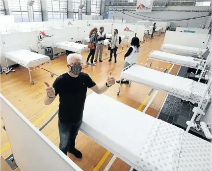  ?? Picture: Esa Alexander ?? Western Cape Premier Alan Winde and Médecins Sans Frontières officials visit Khayelitsh­a’s Covid-19 field hospital, which has 68 beds on the basketball and netball courts of a community centre.