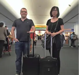  ?? SCOTT MAYEROWITZ/AP ?? Scott Mayerowitz and Candice Choi are ready for departure at New York’s LaGuardia Airport. AP sent them on a two-day visit to Orlando, Florida — Mayerowitz with perks, Choi without.