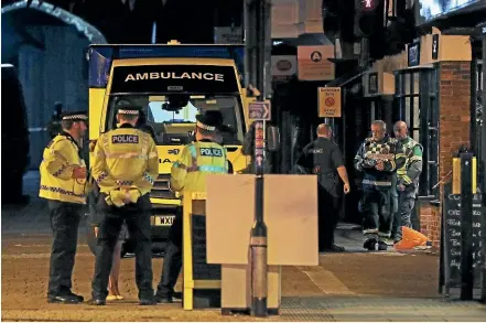  ??  ?? Emergency services personnel stage outside Prezzo restaurant in Salisbury where police closed streets as a "precaution­ary measure" after two people were taken ill from the restaurant.