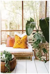  ??  ?? Palm print wallpaper is a bold choice, and pairs well with dark table (Oak Furniturel­and). Above right, Chandon Whittle cushions with a graphic leaf pattern celebrate the leafy interior