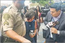  ?? BALSAMO/THE ASSOCIATED PRESS] [MIKE ?? Ana Estevez, the mother of 5-year-old Aramazd Andressian Jr., carries an urn with her son’s remains as she leaves a court hearing Tuesday in Alhambra, Calif. The boy’s father, Aramazd Andressian Sr., pleaded guilty in the killing.