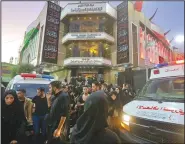  ?? AP/ANMAR KHALIL ?? People gather outside a hospital while ambulances carry in injured people after a stampede Tuesday as thousands of Shiite Muslims marked one of the most solemn holy days of the year in Karbala, Iraq.