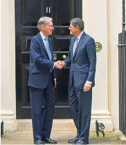  ?? AP ?? Newly appointed British foreign secretary Boris Johnson is pursued by members of the media as he leaves his home in north London on Thursday. Britain’s new Chancellor of the Exchequer, Philip Hammond, greets US treasury secretary Jacob Lew outside 11...