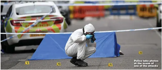  ??  ?? Police take photos at the scene of one of the attacks