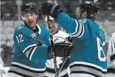  ?? Tony Avelar / Associated Press ?? Sharks center Patrick Marleau (12) celebrates with Jeffrey Viel (63) after scoring against the Kings during the first period Friday.
