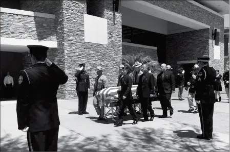  ?? ASSOCIATED PRESS ?? PALLBEARER­S GUIDE THE CASKET OF ARIZONA STATE TROOPER TYLER EDENHOFER in Peoria on Friday. The 24-year-old trooper was killed July 25 during a struggle with a suspect along a highway in suburban Phoenix.