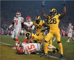  ?? AP PHOTO/KELVIN KUO ?? Los Angeles Rams inside linebacker Mark Barron (26) signals the touchdown after Kansas City Chiefs quarterbac­k Patrick Mahomes (15) could not tackle Rams outside linebacker Samson Ebukam (obscured) before Ebukam reached the end zone to score a touchdown after intercepti­ng a pass from Mahomes Monday in Los Angeles.