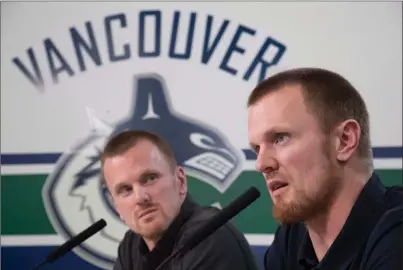  ?? The Canadian Press ?? Vancouver Canucks captain Henrik Sedin, right, and twin brother Daniel Sedin announced their retirement during a news conference at Rogers Arena in Vancouver on Monday.