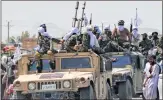  ?? -AFP ?? Taliban fighters atop Humvee vehicles parade along a road to celebrate after the US exit in Kandahar on Wednsday.
