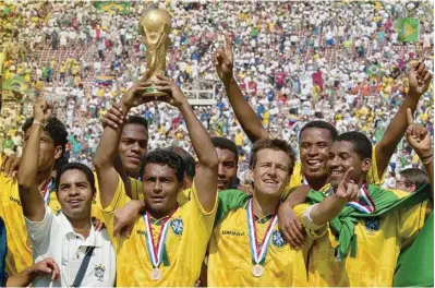  ??  ?? Romario, who was voted best player of the tournament, lifts the FIFA World Cup after Brazil won the penalty shoot-out against Italy in the final. Photo: FIFA Brazil players Bebeto and Marcio Santos hold a banner in homage to Formula One legend Ayrton...