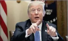  ?? ANDREW HARNIK — THE ASSOCIATED PRESS ?? President Donald Trump points to members of the media as he speaks Wednesday during a meeting with inner-city pastors in the Cabinet Room of the White House.