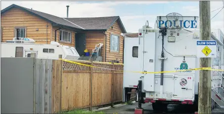  ?? ARLEN REDEKOP/PNG ?? Police tape cordons off a home Monday at 6116 - 14th Ave. Burnaby.