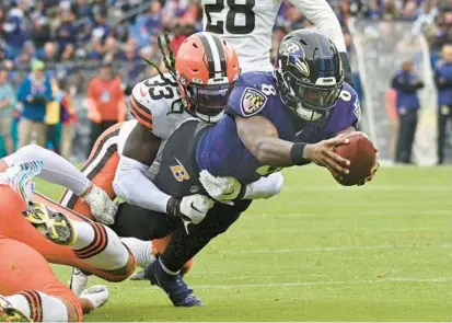  ?? KENNETH K. LAM/BALTIMORE SUN ?? Ravens quarterbac­k Lamar Jackson, diving for a first down during a game against the Cleveland Browns on Oct. 23, will be able to start shopping for a deal Monday and could sign an offer sheet once free agency starts March 15.