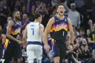  ?? AP photo ?? The Suns’ Devin Booker celebrates during the first half Monday.