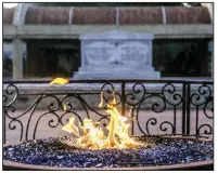  ?? (AP/Atlanta Journal-Constituti­on/Branden Camp) ?? An eternal flame burns at the tomb of the Rev. Martin Luther King Jr. and his wife Coretta Scott King on Monday in Atlanta.