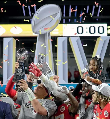  ?? GETTY IMAGES ?? Kansas City Chiefs quarterbac­k Patrick Mahomes celebrates with the Vince Lombardi Trophy after beating the San Francisco 49ers 31-20 in Super Bowl LIV in Miami yesterday. Match report on page 32.