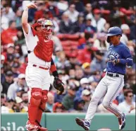  ?? Maddie Meyer / Getty Images ?? The Blue Jays’ Gosuke Katoh, right, scores a run against the Red Sox during the third inning at Fenway Park on Thursday.