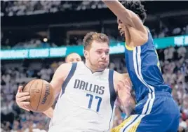  ?? TONY GUTIERREZ/AP ?? Andrew Wiggins guards Luka Donic during Game 4 of the Western Conference finals Tuesday. Doncic led the Mavs to the victory, but the Warriors lead the series 3-1.