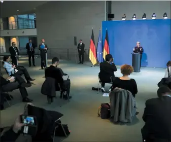  ?? (AP PHOTO/MARKUS SCHREIBER, POOL) ?? German Chancellor Angela Merkel speaks during a news conference about the coronaviru­s, where journalist­s sit spread out, at the chanceller­y in Berlin, Germany, March 16, 2020.