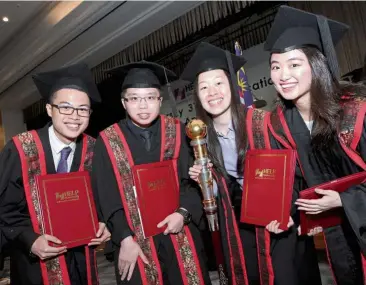  ??  ?? (From left) Tan, Chia Hao Xian, Yap (right) and Loh (second from right) mark their convocatio­n with a photograph.