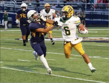  ?? DAVID SCHNEIDER - THE MORNING JOURNAL ?? Amherst’s Khennedy Scagliozzo stiff-arms Marcus McLean of North Ridgeville during a second-quarter run on Sept. 7.