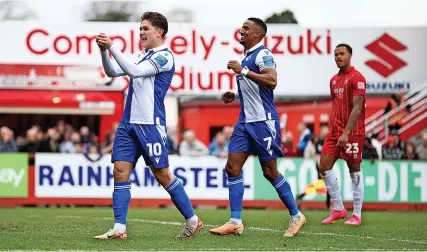  ?? Picture: Will Cooper/EFL ?? Brandon Aguilera, left, celebrates scoring Bristol Rovers’ second goal in Saturday’s 3-1 League One victory against Cheltenham Town