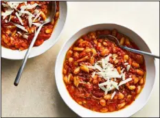  ?? ?? Made in about half an hour from pantry ingredient­s, this simple, flexible stew has a velvety texture from canned white beans rounded out by plenty of garlic, olive oil and canned plum tomatoes.