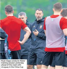  ??  ?? Ryan Giggs conducts Wales’ training session yesterday ahead of the clash with Uruguay in the China Cup