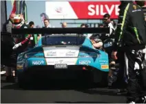  ?? – Supplied photo ?? SO NEAR YET SO FAR: Oman Racing’s Ahmad Al Harthy, left, pictured during a pit stop at the Silverston­e circuit.