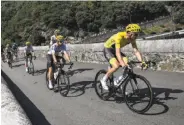  ?? Lionel Bonaventur­e / AFP / Getty Images ?? Chris Froome, in the yellow jersey, rides on a bridge ahead of his teammate Mikel Landa.