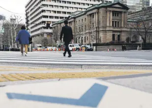  ?? ?? People walk in front of the Bank of Japan (BOJ) building in Tokyo, Japan, Jan. 23, 2024.