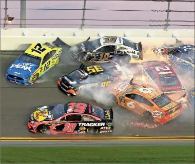  ?? / AP-Gary McCullough ?? Multiple cars crash in turn 3 during the NASCAR Daytona 500 at Daytona Internatio­nal Speedway in Daytona Beach, Fla., on Sunday. The Daytona 500 packed an unforeseen punch that, if nothing else, entertaine­d Sunday’s sun-drenched, soldout crowd at the famed “World Center of Racing.”