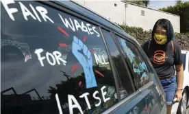  ?? J Chun/Los Angeles Times/Rex/Shuttersto­ck ?? Crystal Kan, a storyboard artist, draws signs on union members’ cars during a rally at the Motion Picture Editors Guild IATSE Local 700 on Sunday in Los Angeles. Photograph: Myung