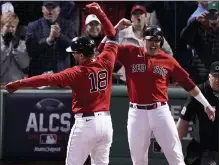  ?? AP ?? Kyle Schwarber celebrates his second inning grand slam with Hunter Renfroe on Monday night at Fenway Park.