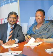  ?? /Supplied ?? Stamp of approval: Petroleum Agency SA CEO Lindiwe Mekwe, right, and Tosaco chairman Kinesh Pather sign documents.