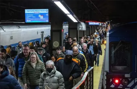  ?? Eduardo Munoz Alvarez/Associated Press ?? Travelers walk along the platform as they arrive at Grand Central Terminal in New York on Thursday.