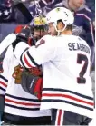 ?? Brent Seabrook congratula­tes Corey Crawford after his victory against the Jackets.
GETTY IMAGES ??