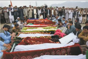  ?? Arshad Butt / Associated Press 2019 ?? Relatives wait to bury the victims of a suicide bomber at a funeral in Quetta, Pakistan last year. Pakistan has gone from thousands of terrorist attacks annually to fewer than 250 last year.