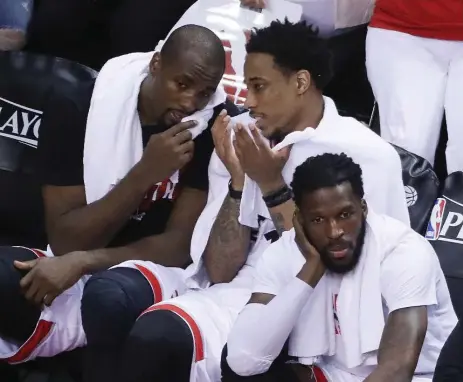  ?? STEVE RUSSELL/TORONTO STAR ?? Serge Ibaka, DeMar DeRozan and DeMarre Carroll watch the final minutes if the Raptors’ 115-94 loss in Game 3 against Cleveland. Game 4 is Sunday.